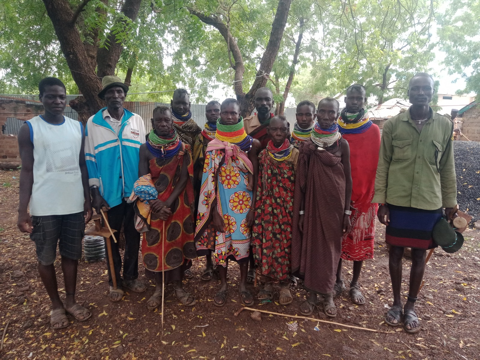 Community members and elders standing together under trees in Turkana